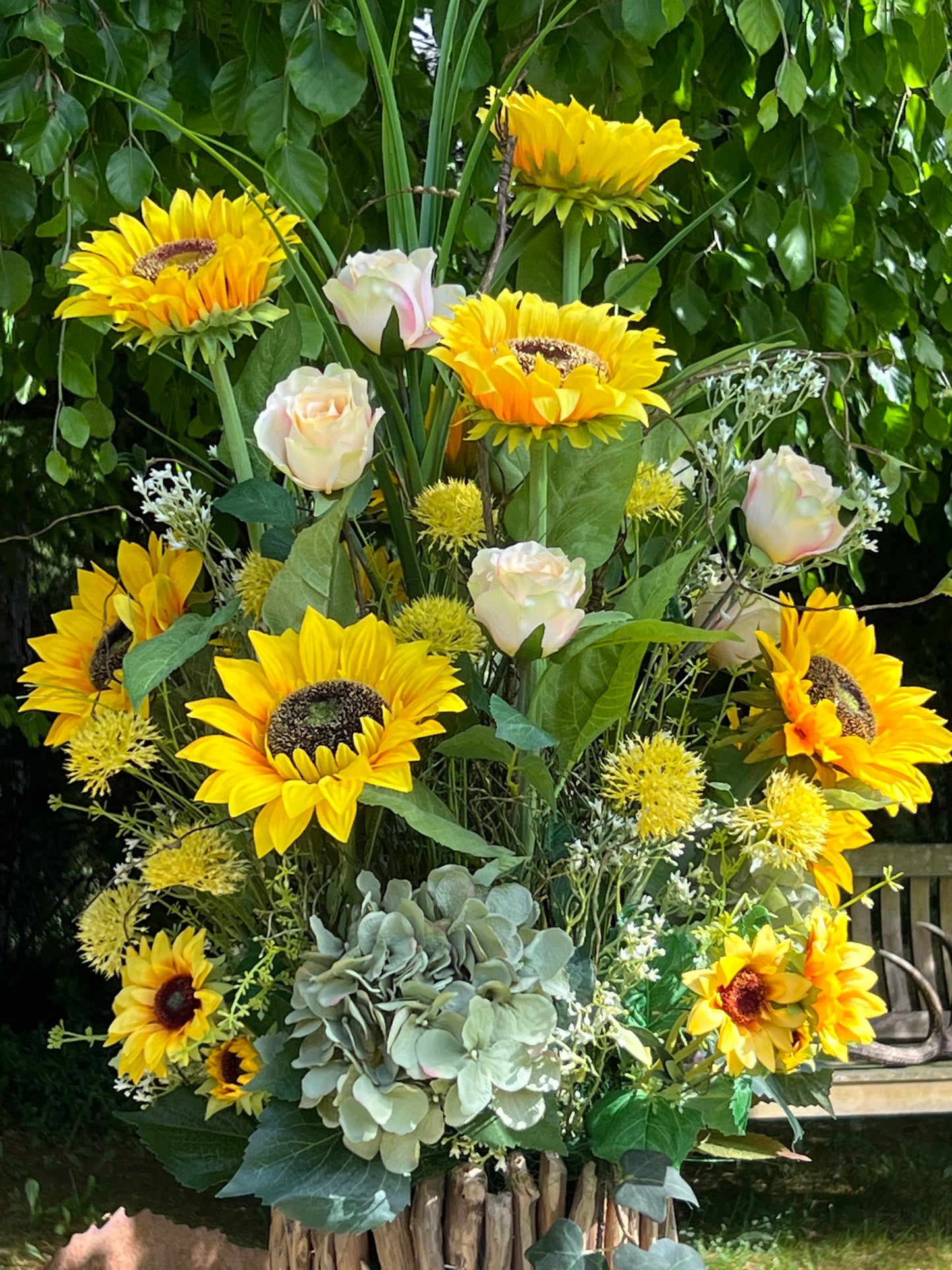 Blumengesteck in einer Holzvase
